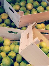 Full frame shot of lemons in crates at market stall