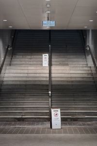 Low angle view of illuminated text on wall at subway station