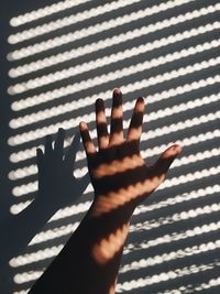 Cropped image of hand against wall