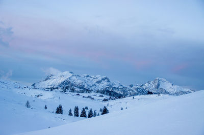 Scenic view of snow covered mountains against sky