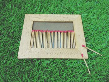 High angle view of wooden seat on field