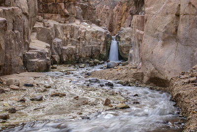 The waterfall and running river across the sandstone rocks