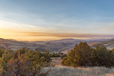 Scenic view of mountains against sky during sunset