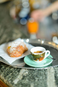 Espresso coffee and custard pastry cream croissant for a caloric