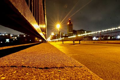 Illuminated bridge against sky at night