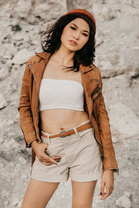 Beautiful young woman standing outdoors