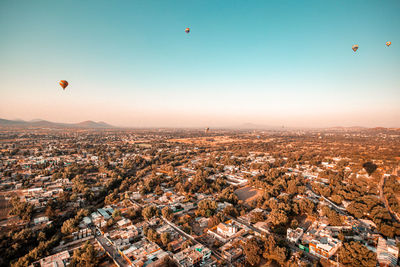 Aerial view of city against sky during sunset