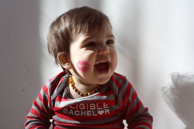 Portrait of cute girl with lipstick kiss on face