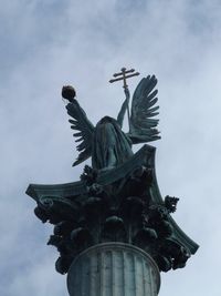 Low angle view of statue against cloudy sky