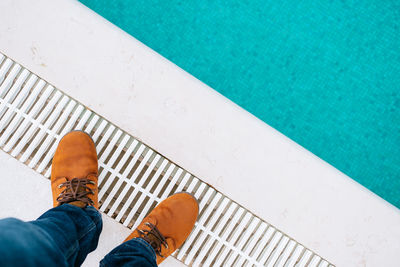 Low section of person standing on poolside