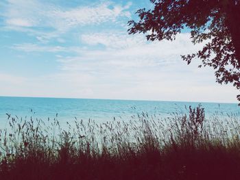 Scenic view of sea against cloudy sky