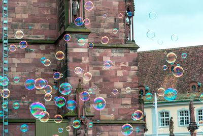 Low angle view of bubbles against building