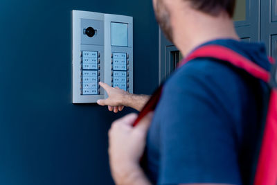 Rear view of man using mobile phone