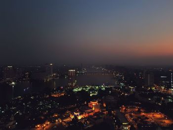 High angle view of illuminated buildings in city at night