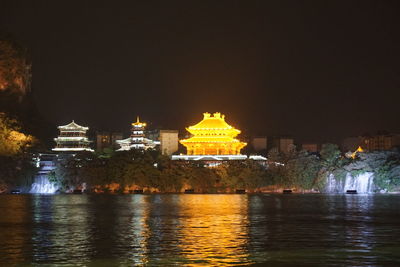 Illuminated buildings at waterfront