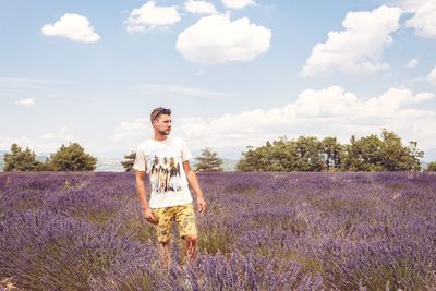 Man standing in field against sky