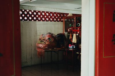 Portrait of woman in red mirror at home