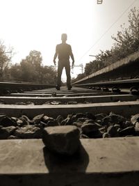 Rear view of man on railroad track