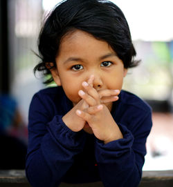 Portrait of girl with hands clasped