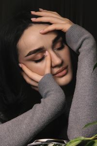 Portrait of young woman sitting at home