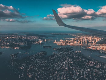 Aerial view of cityscape and sea against sky