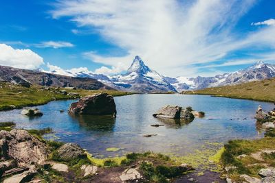 Scenic view of lake and mountains against sky