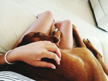 Low section of man relaxing on bed