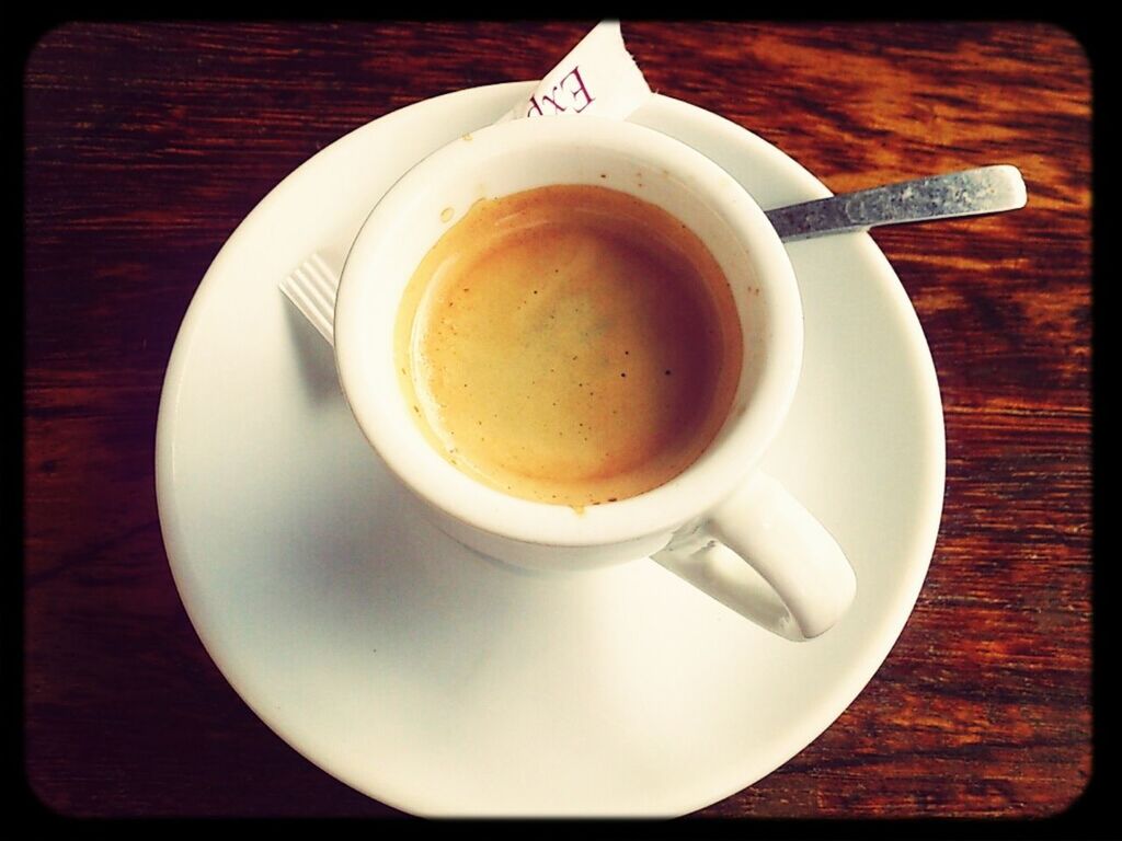 food and drink, coffee cup, drink, indoors, refreshment, table, freshness, coffee - drink, saucer, spoon, coffee, still life, cup, high angle view, directly above, close-up, beverage, frothy drink, healthy eating, breakfast