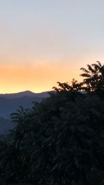 Scenic view of silhouette mountains against sky at sunset