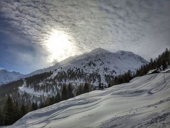 Scenic view of snow covered mountains against sky