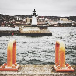 Close-up of retaining wall by sea against sky