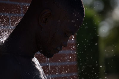 Head of man with water drops