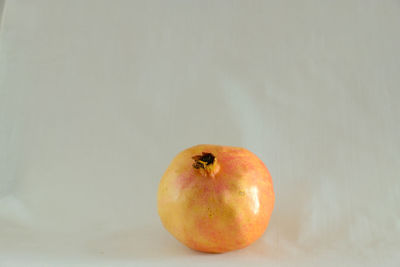 Close-up of apple on table against white background