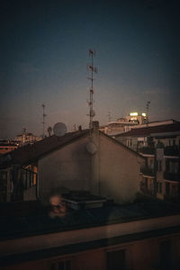 Street amidst buildings against sky at dusk