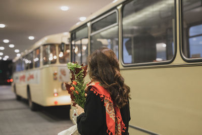 Rear view of woman standing at train