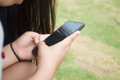 Midsection of man using mobile phone