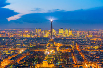 Aerial view of city lit up at night