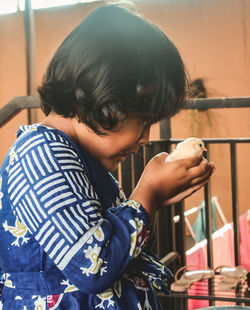 Portrait of boy holding camera