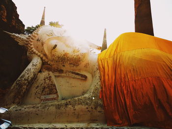 Low angle view of statue against temple building