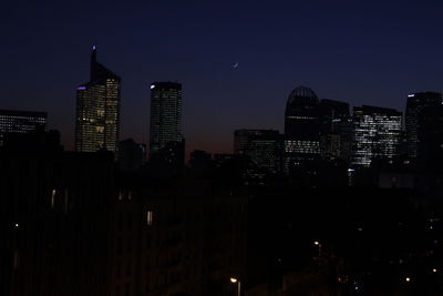 Low angle view of skyscrapers lit up at night