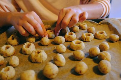 Midsection of person preparing cookies