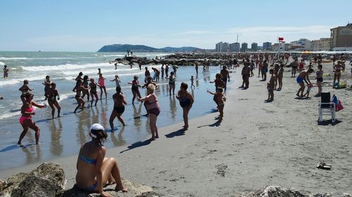 People on beach against sky