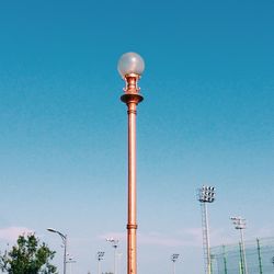 Low angle view of street light against clear blue sky