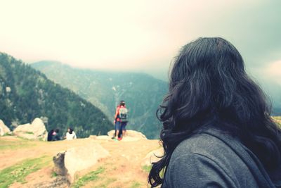 Rear view of woman with arms raised on mountain