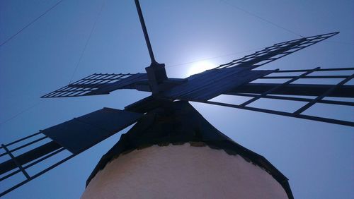 Low angle view of traditional windmill against clear sky