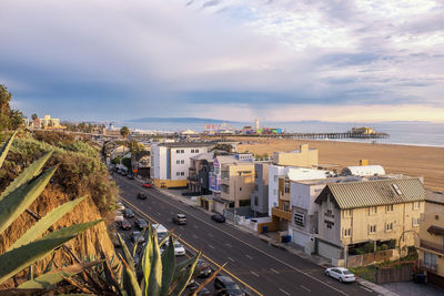 High angle view of road by buildings against sky