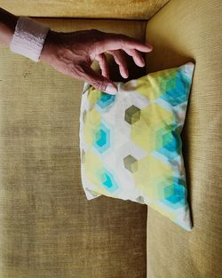 Close-up of hand holding multi colored paper