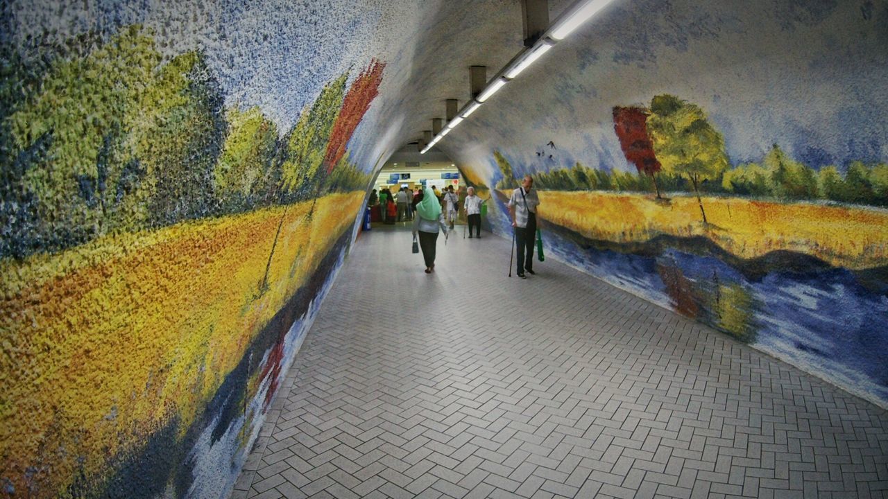 PEOPLE IN TUNNEL IN PARK