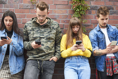 Young man using mobile phone outdoors