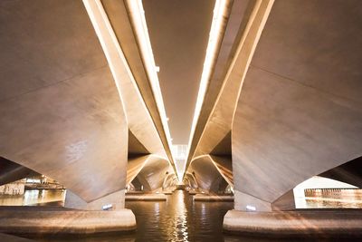 Low angle view of bridge over river against sky at night